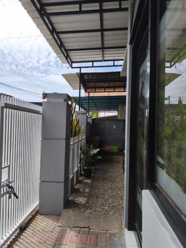 a balcony of a house with a patio at LA LUNA Guest House in Banyuwangi