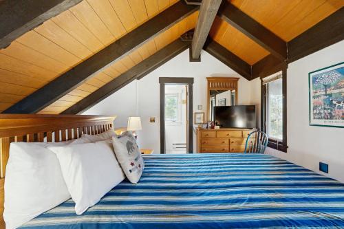 a bedroom with a bed with blue and white sheets at Yellowstone 28B in Big Sky