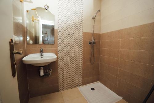 a bathroom with a sink and a shower at Namaste Lodge Experience in Taghazout