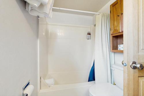 a bathroom with a shower and a toilet at Yellowstone 28B in Big Sky