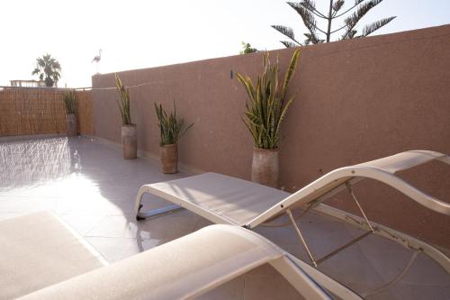 a white chair and a table on a patio at Namaste Lodge Experience in Taghazout