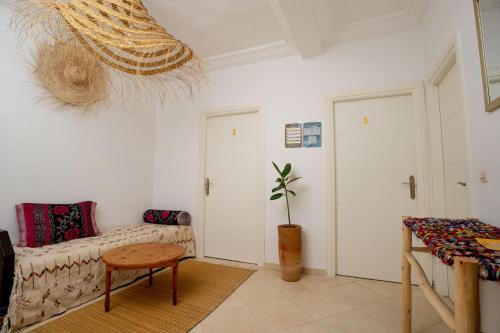 a living room with a couch and a table at Namaste Lodge Experience in Taghazout