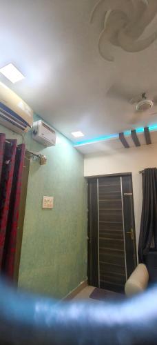 a room with a green wall and a door at Ajith imperial in Mahabalipuram