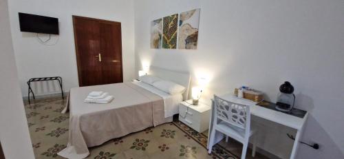 a small bedroom with a bed and a desk at B&B Gaudio in San Marco Argentano