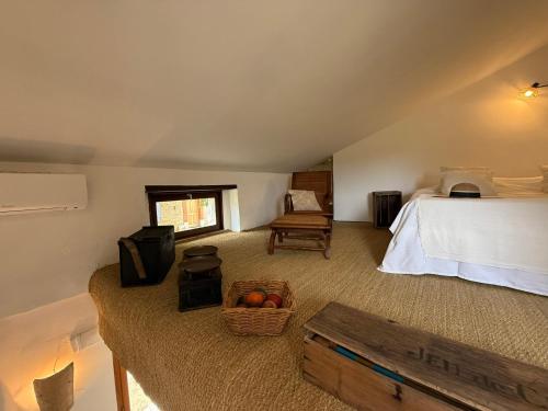 a bedroom with a bed and a basket of fruit at Le Clos des Pigières le Gîte de la Pierre a eau in Vaison-la-Romaine