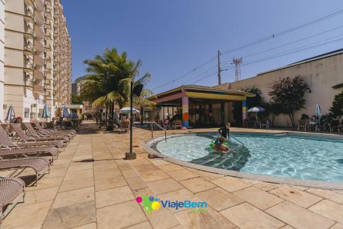 a swimming pool in a resort with people in it at DiRoma Exclusive Caldas Novas in Caldas Novas