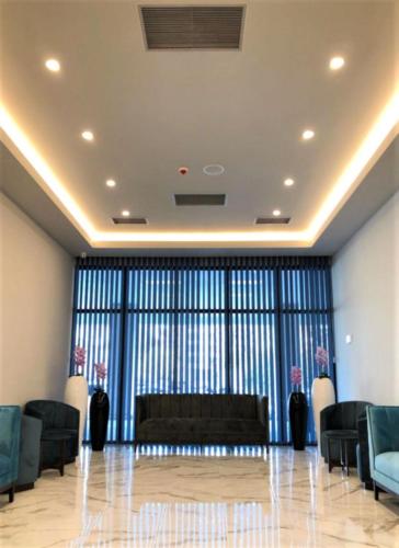 a lobby with a couch and a large window at Picturesque Sea View Aparthotel In Orbi City Batumi in Batumi