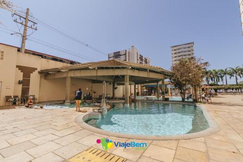 a swimming pool in a courtyard with a building at DiRoma Exclusive Caldas Novas in Caldas Novas