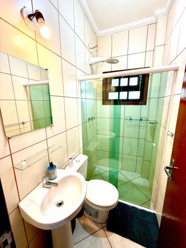 a bathroom with a sink and a shower and a toilet at Apartamento à beira-mar Ilha Comprida in Ilha Comprida