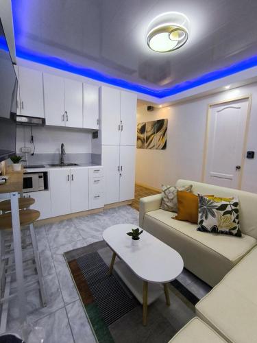 a living room with a couch and a table at AMS Apartment in Butuan