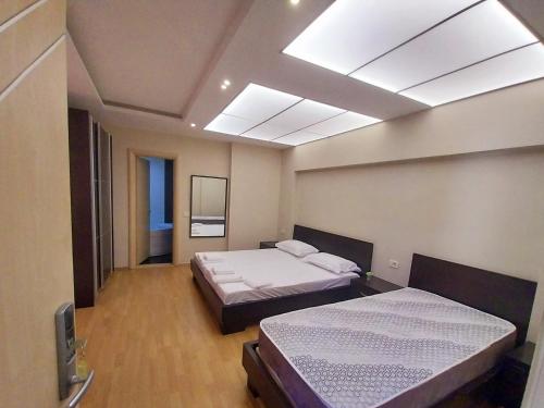 a bedroom with two beds and a skylight at Danis Hotel in Golem
