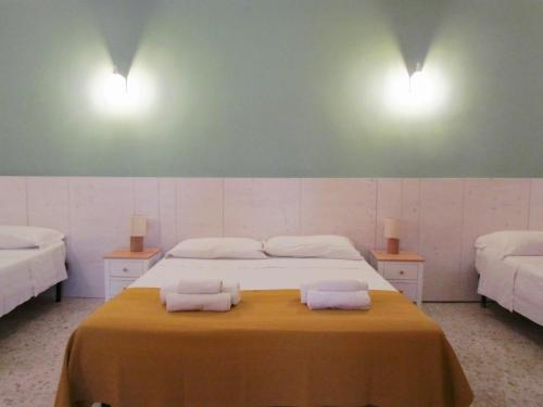 a bedroom with a bed with two towels on it at Arco Michele in Putignano