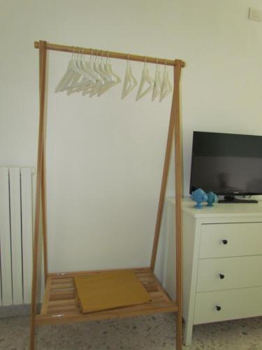 a wooden frame with utensils hanging from a wall at Arco Michele in Putignano