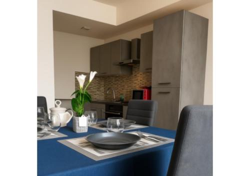 a dining room table with a blue table cloth at Chic house in Avezzano