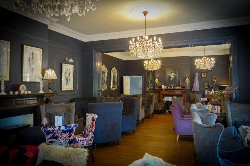 a waiting room with chairs and a chandelier at Brockley Hall Hotel in Saltburn-by-the-Sea