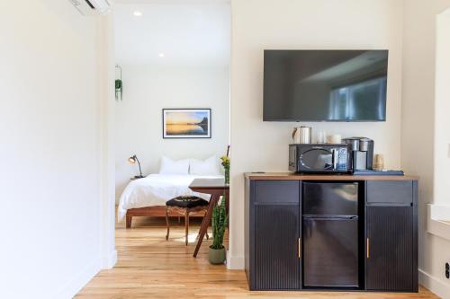 a bedroom with a bed and a tv on a wall at The Historic Schoolhouse Inn in Trinidad