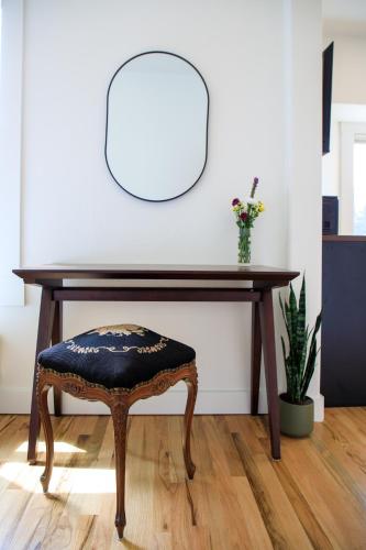 a wooden desk with a chair and a table with a plant at The Historic Schoolhouse Inn in Trinidad