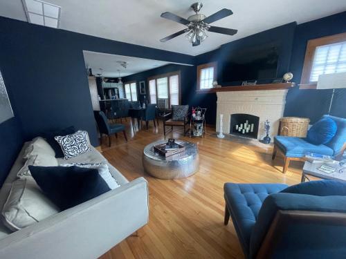 a living room with a couch and a fireplace at Get Kozy in Kenwood in Syracuse