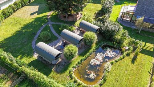 an overhead view of a garden with three white tanks at 4 Elements Glamping & Apartments in Bled