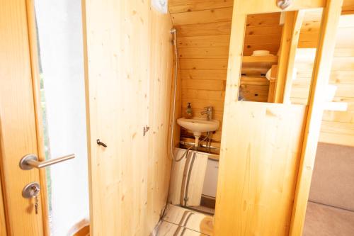 a small bathroom with a sink and a toilet at 4 Elements Glamping & Apartments in Bled