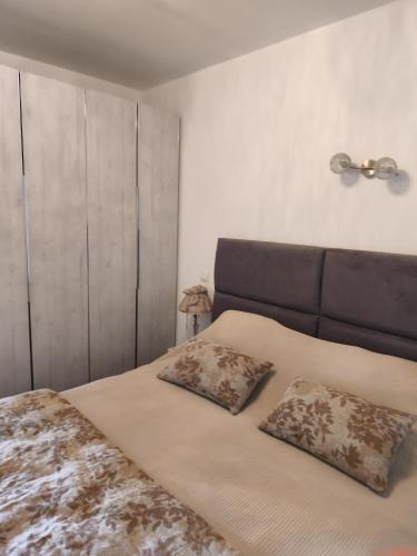 a bedroom with a bed with two pillows on it at La maison d Adélaïde in Saint-Laurent-dʼAigouze