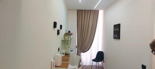 a white room with a desk and a window at Pignasecca Domus in Naples