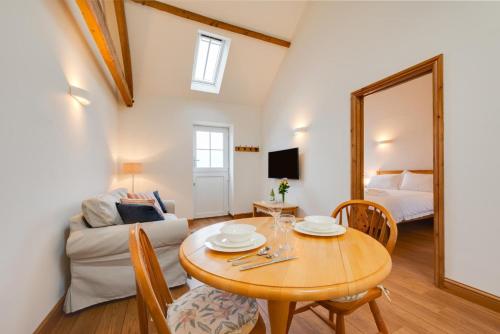 a living room with a table and a couch at The Dairy in Quidenham