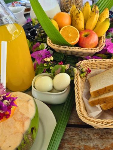 a table with baskets of fruit and bread and eggs at Scuba Haven Fuvahmulah in Fuvahmulah