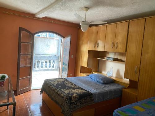 a bedroom with a bed and an open door at Casa MISMA in Sao Paulo