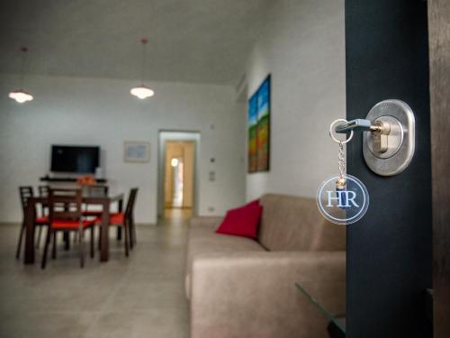 a doorhandle to a living room with a couch and a table at Home Relax in Ordona