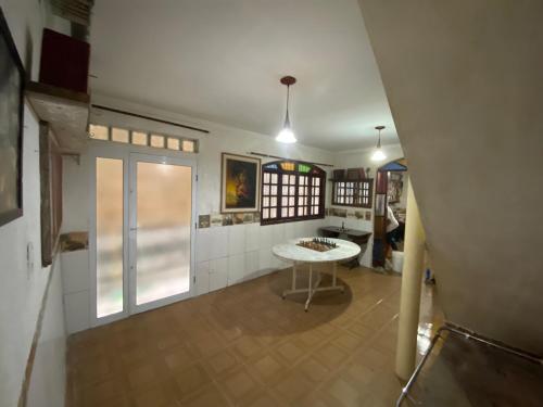 a living room with a table and a window at Casa MISMA in Sao Paulo