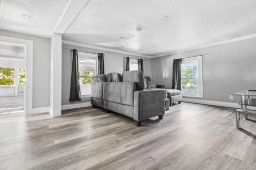 a living room with a chair and a couch at 5BR Home-Walk to Niagara Falls & Aquarium in Niagara Falls