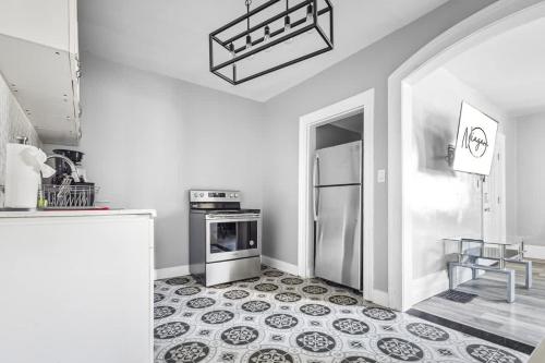 a kitchen with a refrigerator and a stove at 5BR Home-Walk to Niagara Falls & Aquarium in Niagara Falls