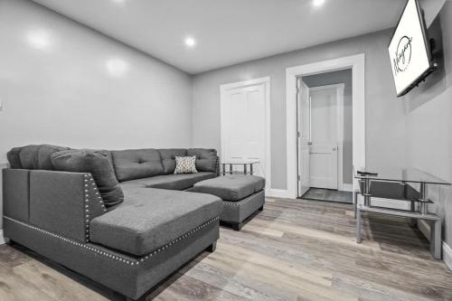 a living room with a couch and a chair at 5BR Home-Walk to Niagara Falls & Aquarium in Niagara Falls