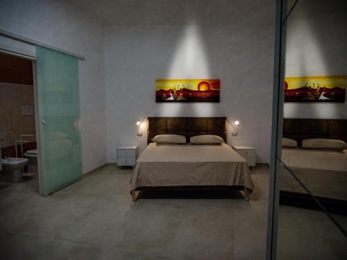 a bedroom with a bed and a bathroom at Home Relax in Ordona