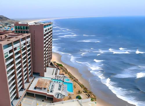 an aerial view of a hotel and the beach at Luxury Beach Condo with Pool in Tijuana