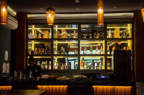 a man sitting at a bar in a restaurant at Hotel de l'Air in Douala