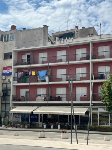 a large red building with a lot of windows at DiSte Apartman in Knin