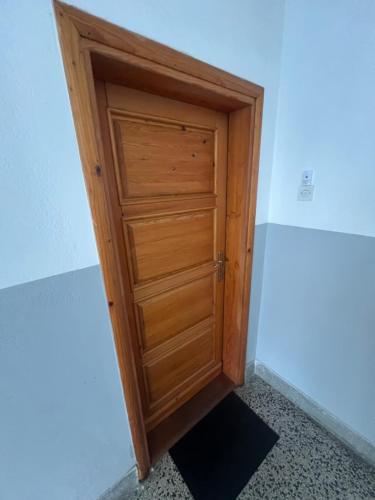 a wooden door in the corner of a room at DiSte Apartman in Knin