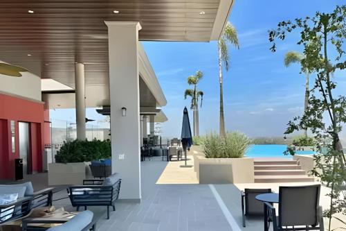 a view of the patio of a resort with tables and chairs at D'Toscana 308 by Del Mar in Nuevo Vallarta 