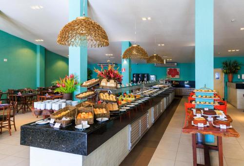 a buffet line with a lot of different types of food at Hotel Solar Porto de Galinhas in Porto De Galinhas