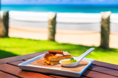a plate of food on a table with a bowl of food at Hotel Solar Porto de Galinhas in Porto De Galinhas