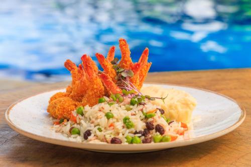 a plate of food with rice and beans on a table at Hotel Solar Porto de Galinhas in Porto De Galinhas
