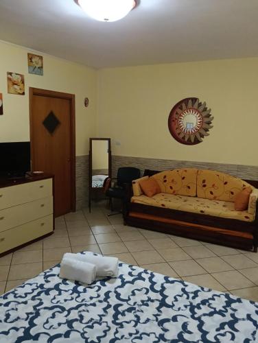 a bedroom with a bed and a mirror on the wall at B&B Fenza in Nocera Inferiore