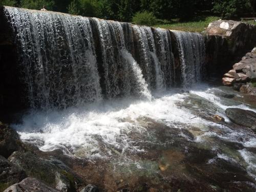 a waterfall with white water rushing down it at La casa dei poeti in Cervasca