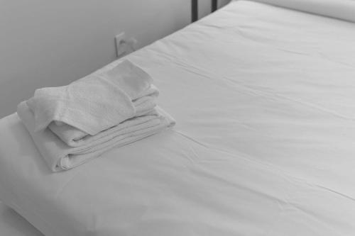 a stack of towels sitting on top of a bed at Dugan Ave Unit B in Owenton
