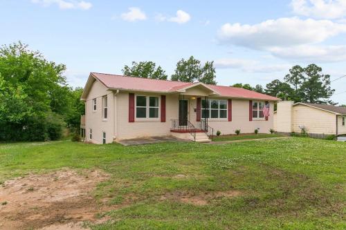 a house with a red roof on a yard at Dugan Ave Unit B in Owenton