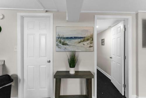 a hallway with a table and a painting on the wall at Dugan Ave Unit B in Owenton
