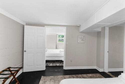 a white room with a bedroom with a bed at Dugan Ave Unit B in Owenton