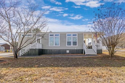 a home with a porch and a house at Byrd 6 Cozy Byrd Nest in Owens Cross Roads